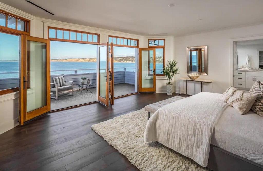a bedroom with a bed and a view of the ocean at La Jolla Cove-Oceanfront 5600SF 3BR+Loft 5BA House best Villiage location walk everywhere in San Diego