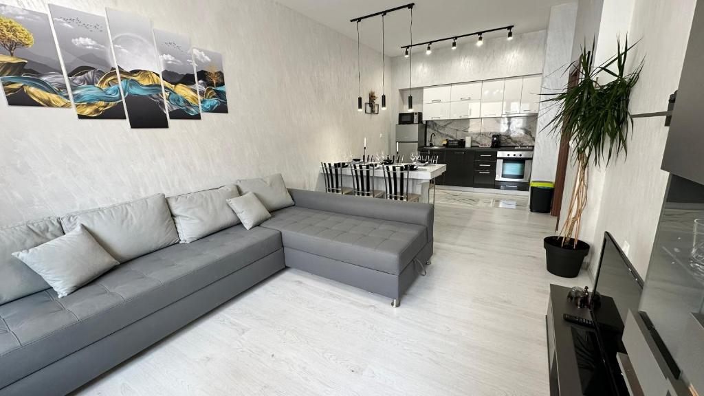 a living room with a couch and a kitchen at LT Apartment in Vratsa