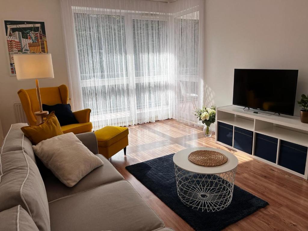 a living room with a couch and a tv at Apartament Stay with Gdynia in Gdynia
