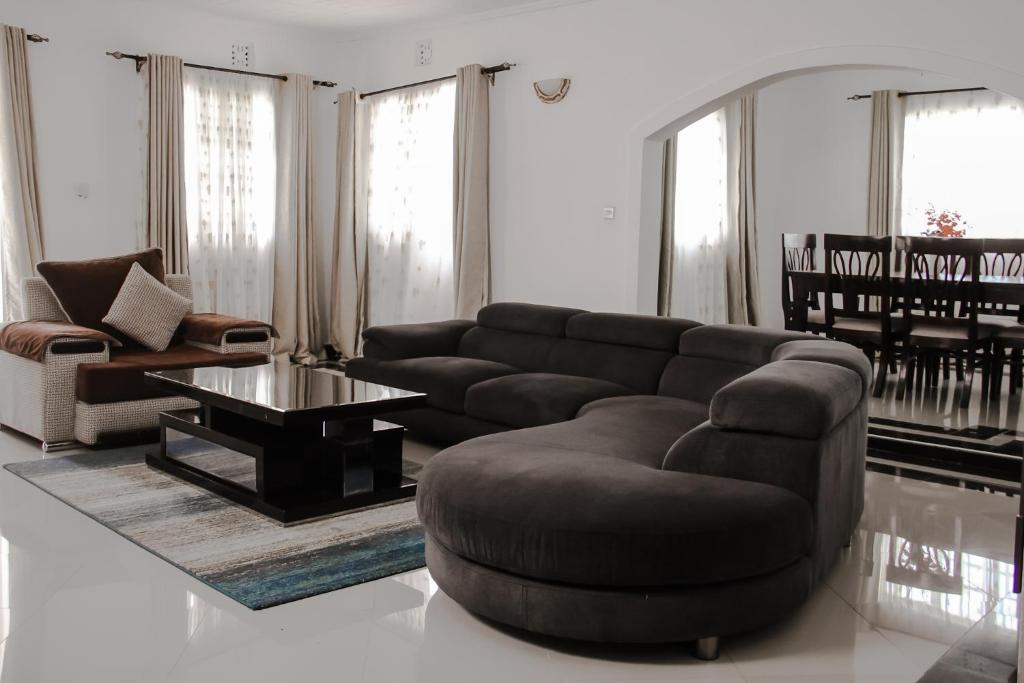 a living room with a couch and a coffee table at Springfield Luxury Homes in Kuywa