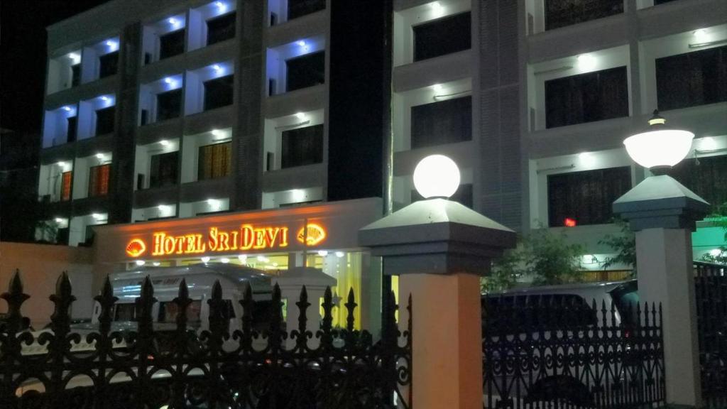 two lights on a fence in front of a building at Hotel Sri Devi in Kanyakumari