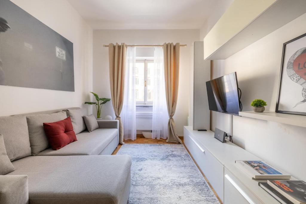 a living room with a couch and a tv at Charming suite with view in the heart of Rome in Rome