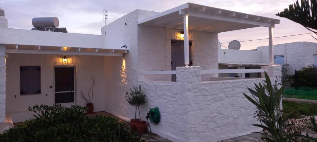 a white house with a white wall at Aretousa Residence in Naoussa, Paros in Naousa