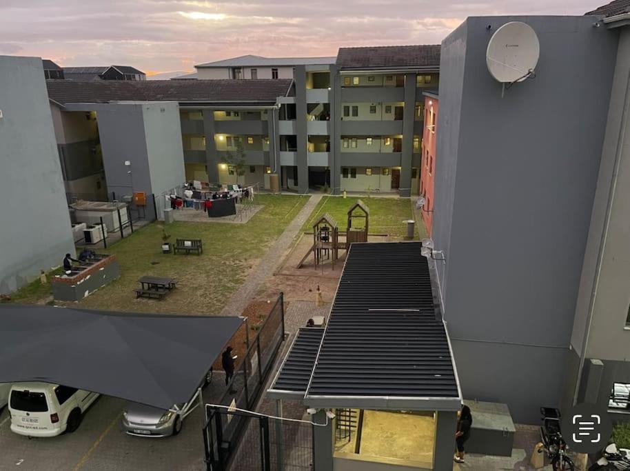 a view of an apartment building with a playground at Rest Easy with 24/7 security in Cape Town