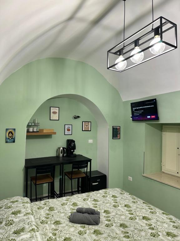 a bedroom with a bed and a table with a desk at Casa Carmelì in Naples