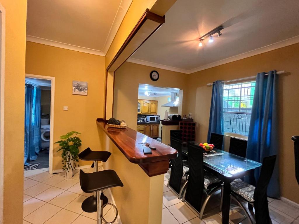 a kitchen and dining room with a table and chairs at Azure Escape in Soufrière