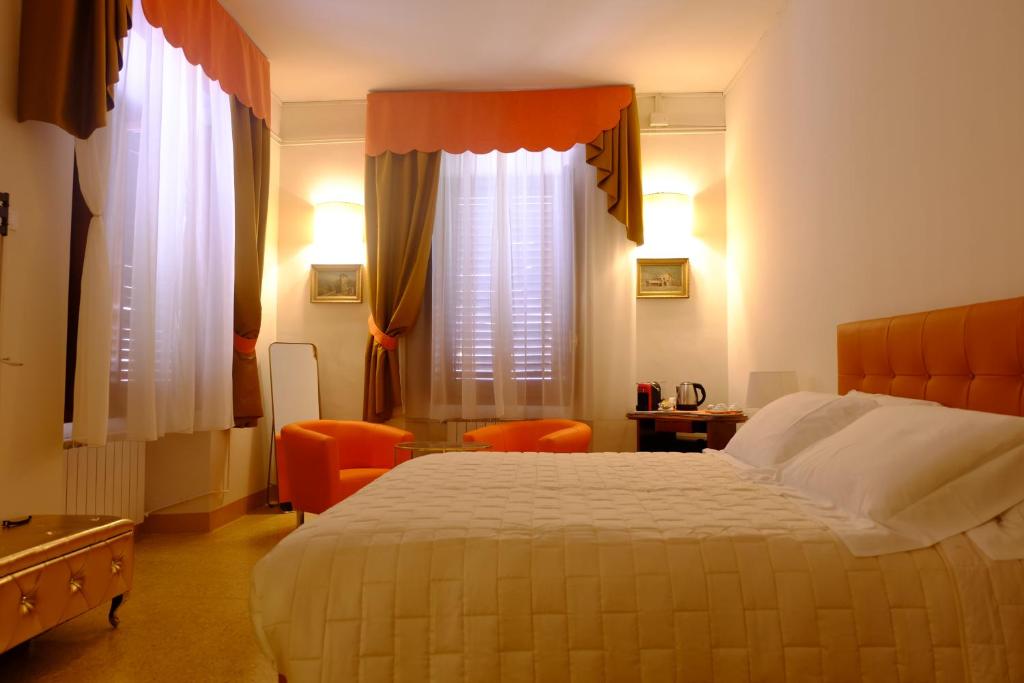 a hotel room with a bed and two windows at Bed & Breakfast Costanza4 in Scanno