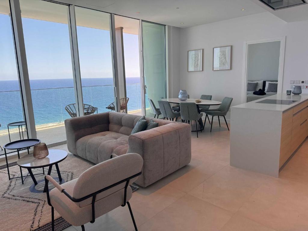a living room with a couch and a table at Ayia Napa Marina Exclusive Apartment in Ayia Napa