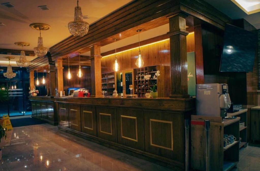 a bar in a restaurant with wooden walls at Apartmani Villa Grande in Bugojno