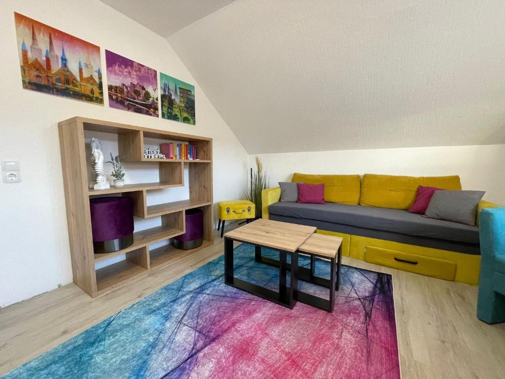 a living room with a couch and a table at Grace Apartment in Grömitz