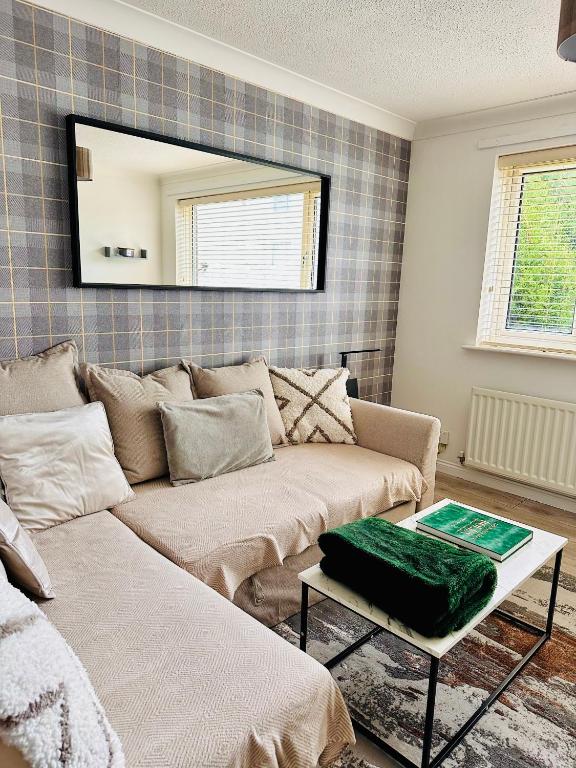 a living room with a couch and a mirror at *Newcastle City* Modern Flat With FREE Parking in Newcastle upon Tyne