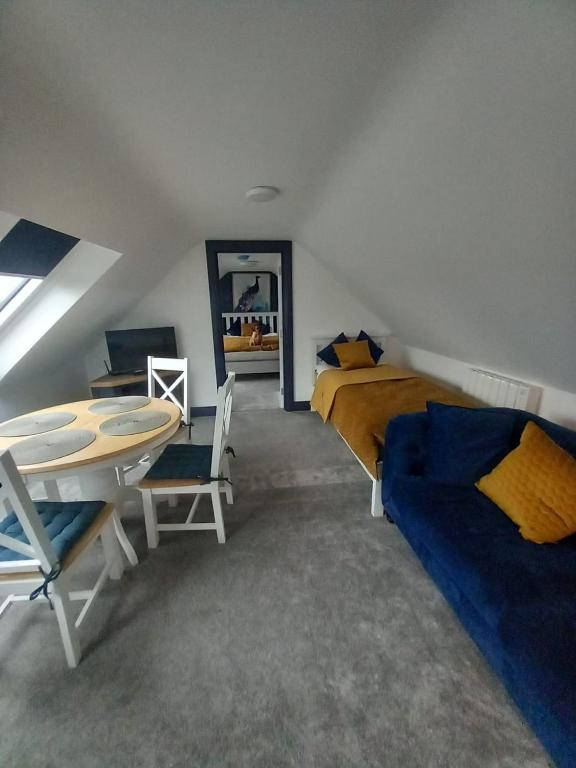 a bedroom with a bed and a desk and a table at The Irish Highlands Haven in Ennis