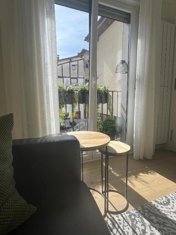 a room with a table and a large window at Apartamentos Sierra in Ezcaray