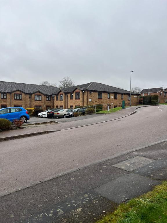 an empty street in front of a row of houses at Quiet single bedroom in Harrowden