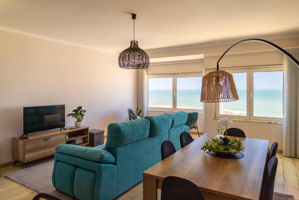 a living room with a blue couch and a table at Blue House in Santa Cruz with Sea View in Santa Cruz