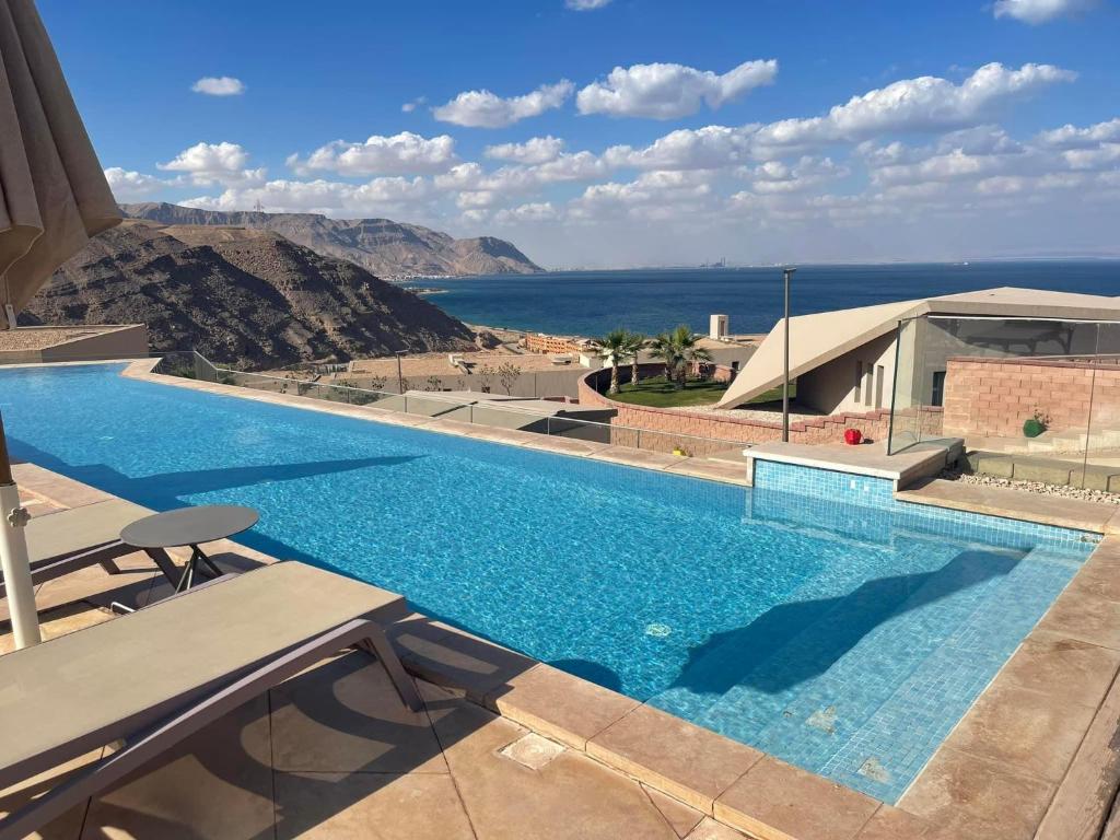 a swimming pool with a view of the ocean at المونت جلاله - ll Monte Galala Ain Sokhna in Ain Sokhna