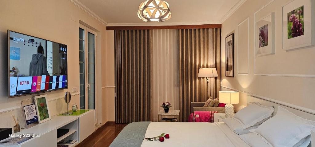 a hotel room with a bed and a television at StayCozy in Lisbon