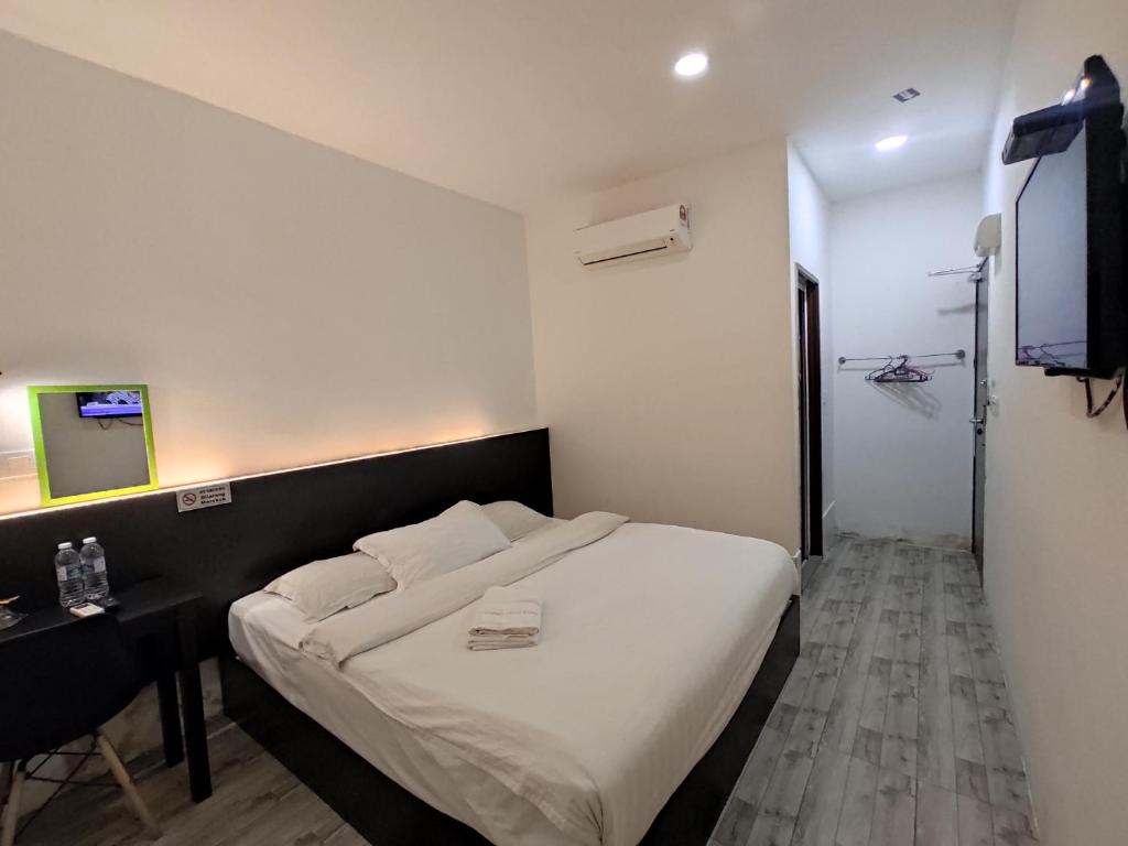 Postel nebo postele na pokoji v ubytování Tambun Warm Hotel