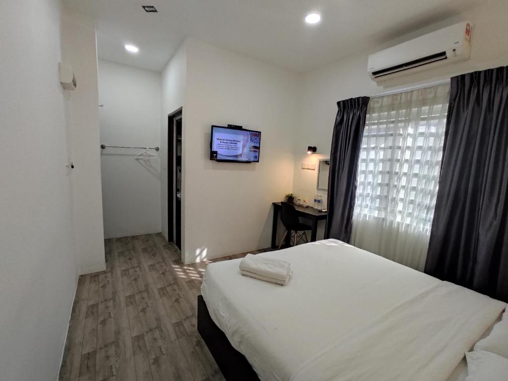Postel nebo postele na pokoji v ubytování Tambun Warm Hotel