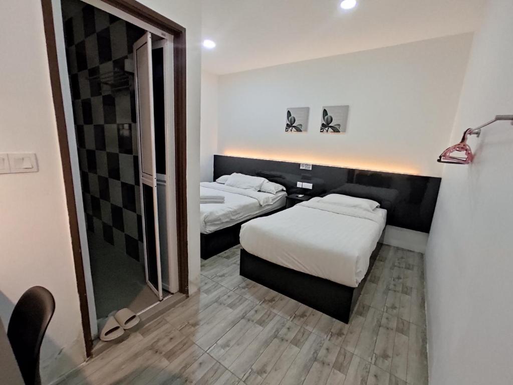 Postel nebo postele na pokoji v ubytování Tambun Warm Hotel