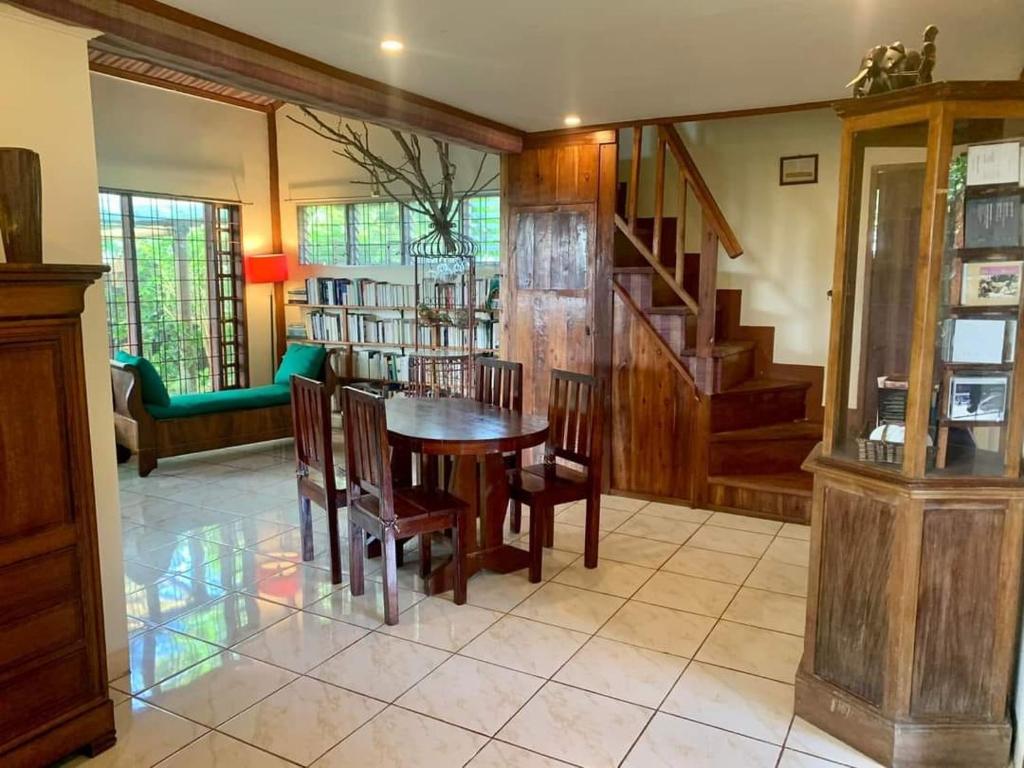 a dining room with a wooden table and chairs at Bliss Accommodation in Malaybalay