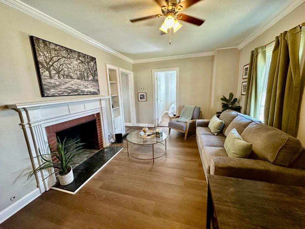 a living room with a couch and a fireplace at Spring Street Suites in Evansville