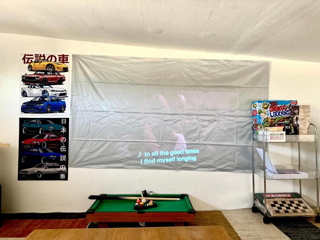 a wall with a banner and a pool table at Sunshine Cabin in General Santos