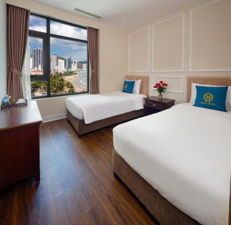 Ένα ή περισσότερα κρεβάτια σε δωμάτιο στο Maro nhatrang beach hotel