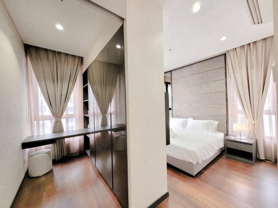 a bedroom with a white bed and a large window at Pavillion @ 8 Kia Peng #10mins walk Pavillion klcc in Kuala Lumpur