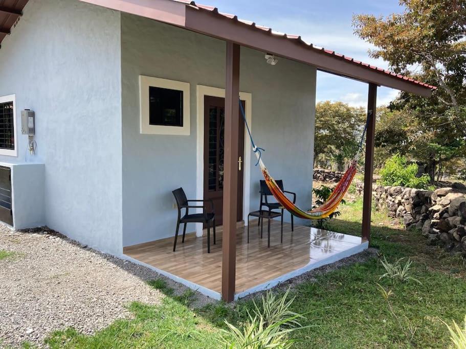 een huis met een terras met een hangmat bij Acogedora cabaña - en Alto Boquete, full equipada in Alto Boquete