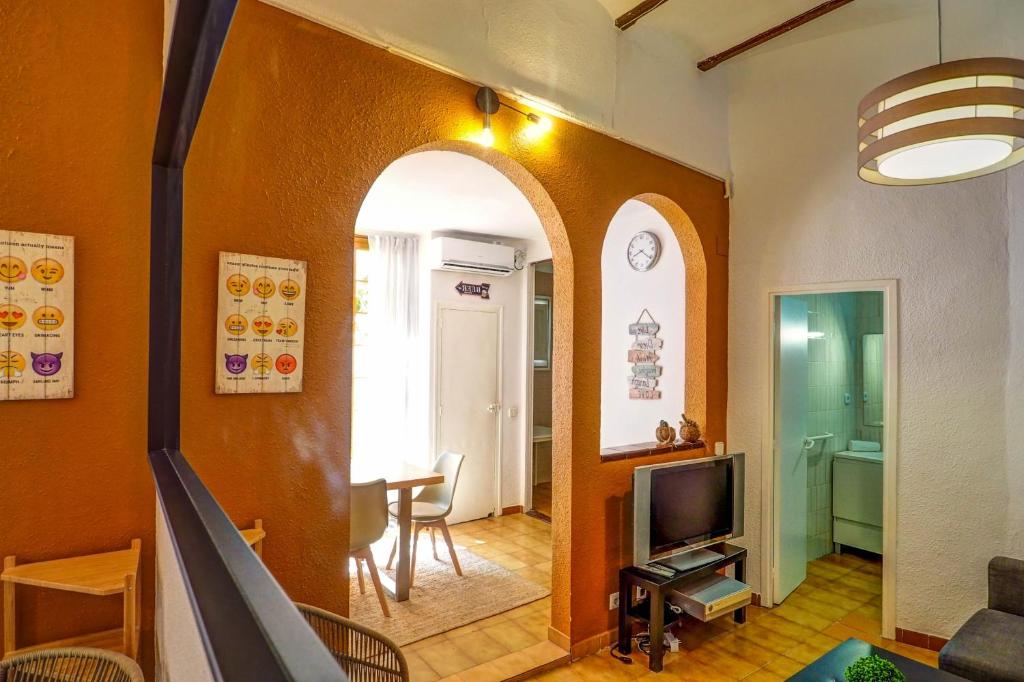 A television and/or entertainment centre at Charming Patio by Hello Homes Sitges