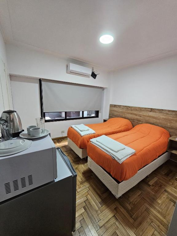 a room with two beds and a sink in it at habitacion comoda cerca del obelisco in Buenos Aires