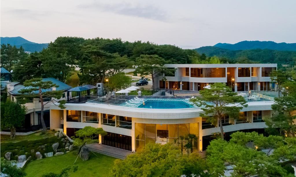 einem Luftblick auf ein Gebäude mit einem Pool in der Unterkunft Goseong hansan marina in Goseong