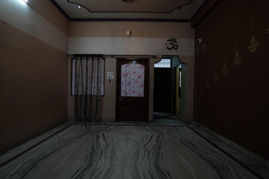 an empty room with a door and a window at hotel banaras darbar in Kakarmatha