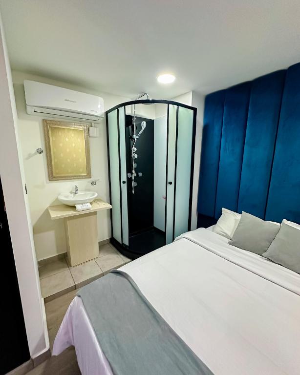 Postel nebo postele na pokoji v ubytování Orbe Hotel Medellín