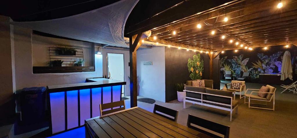 a room with a deck with a bar and lights at Casa Aroma Di Caffee in Yauco