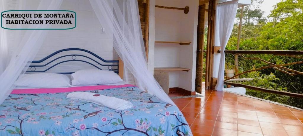 a bedroom with a bed with a canopy at Hostal Ariantiy in Pepino