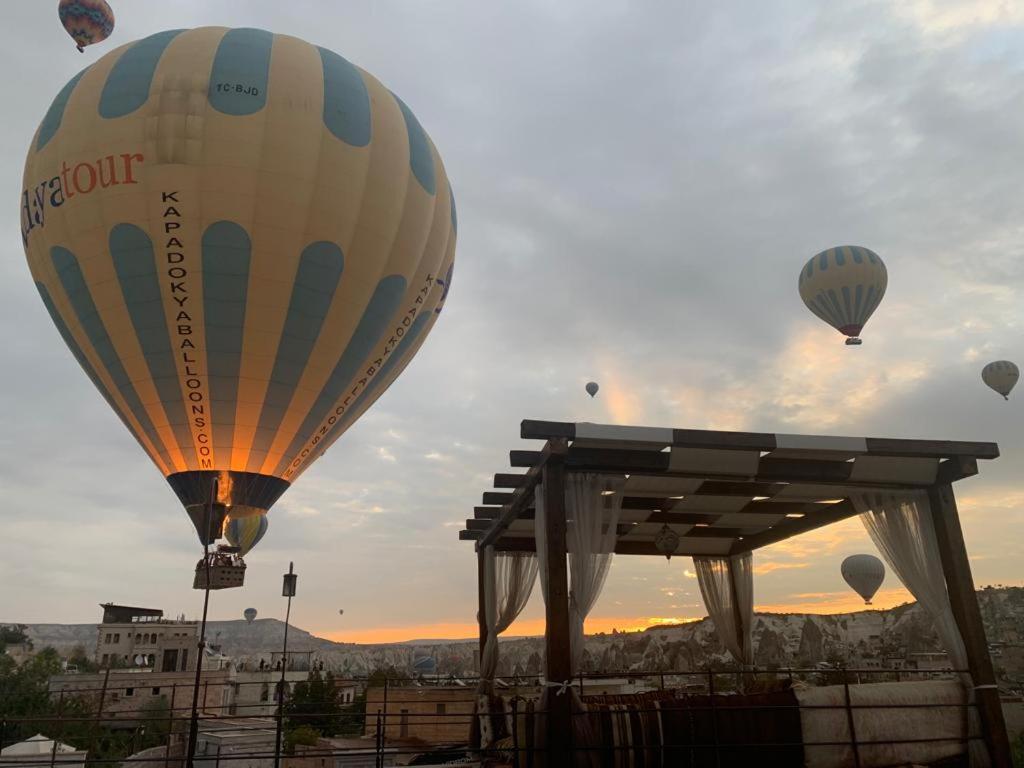 a group of hot air balloons flying in the sky at Alaturca House in Goreme