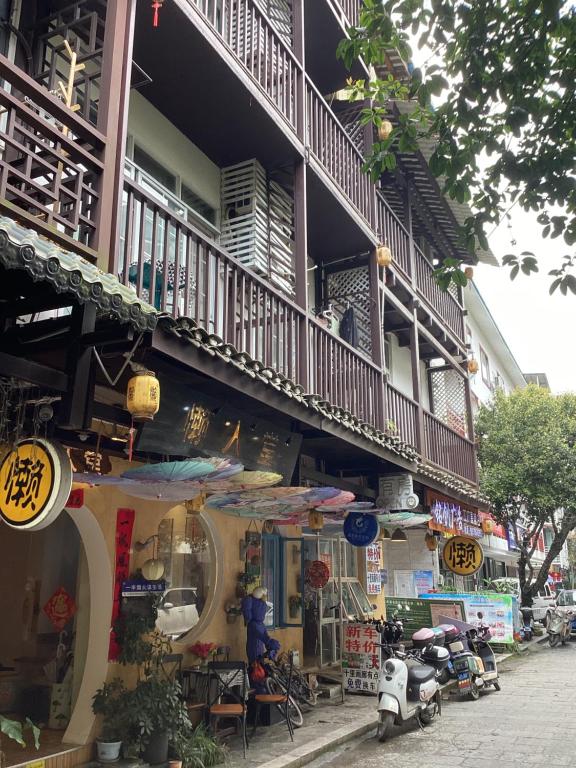 a building with a balcony on the side of it at Lazzy inn in Yangshuo