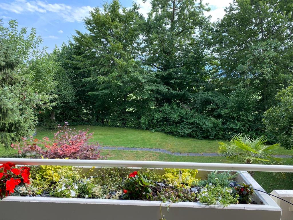 a view of a garden from a balcony at Sempachersee Luzern in Neuenkirch