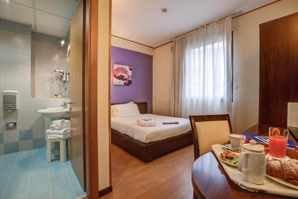 Postel nebo postele na pokoji v ubytování Hotel Europa