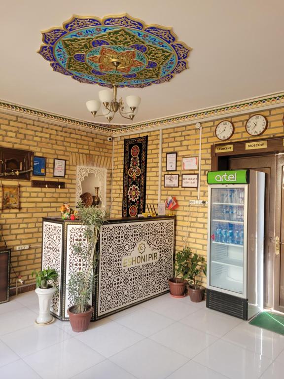 a building with a lobby with a clock on the wall at ESHONI PIR Boutique HOTEL in Bukhara
