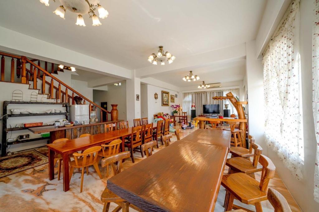 a dining room with wooden tables and chairs at Alps Garden B&amp;B in Wujie