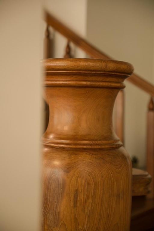 a wooden vase sitting next to a set of stairs at Alps Garden B&amp;B in Wujie