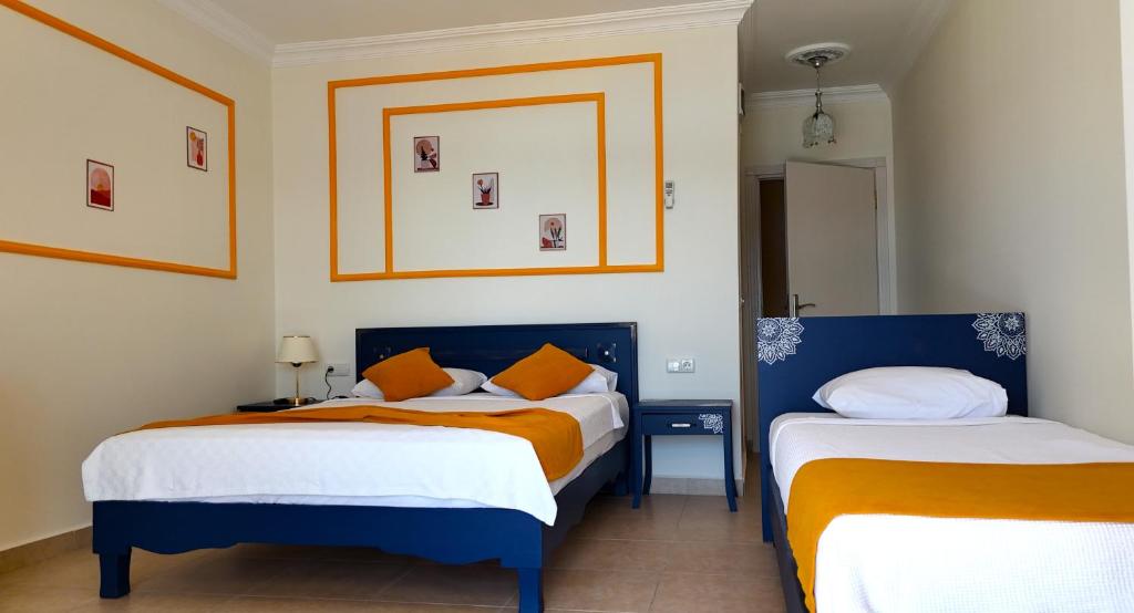 Postel nebo postele na pokoji v ubytování Yazıcı Otel Bozburun