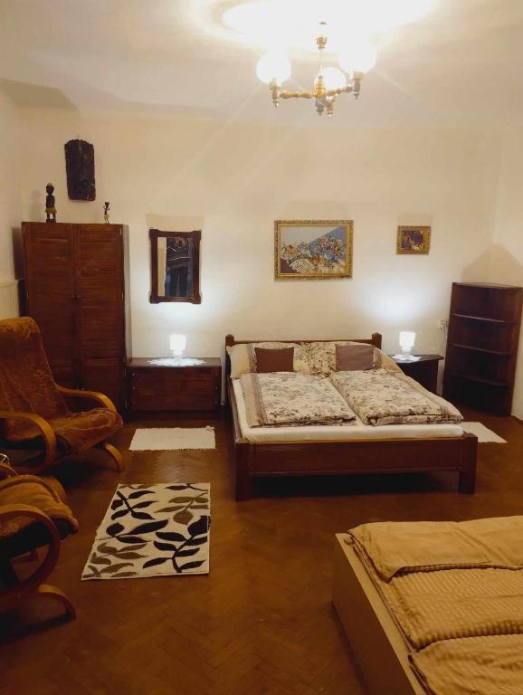 a bedroom with a bed and a chair in it at Apartmán Dolina in Banská Belá