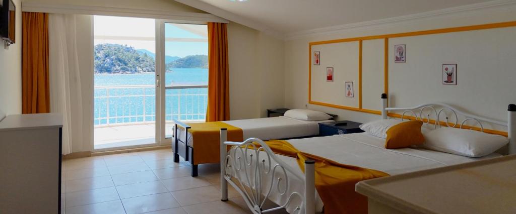 Postel nebo postele na pokoji v ubytování Yazıcı Otel Bozburun