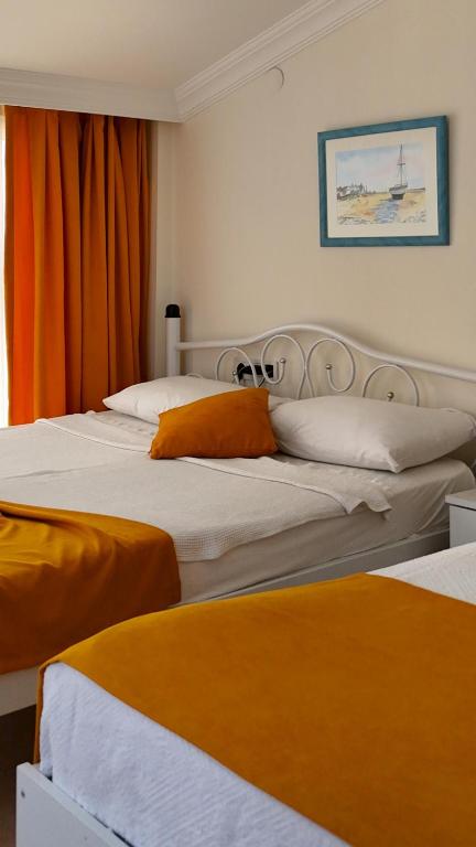 Postel nebo postele na pokoji v ubytování Yazıcı Otel Bozburun