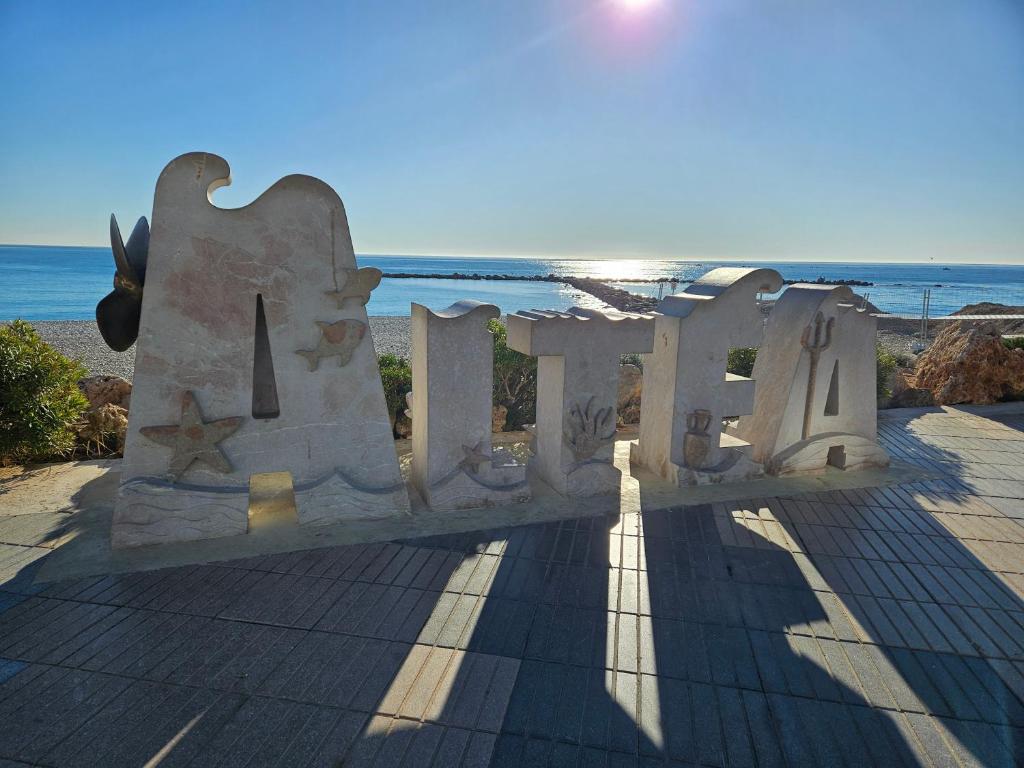 a stone bench with the ocean in the background at HOSTAL LUXURY NIT I DIA in Altea