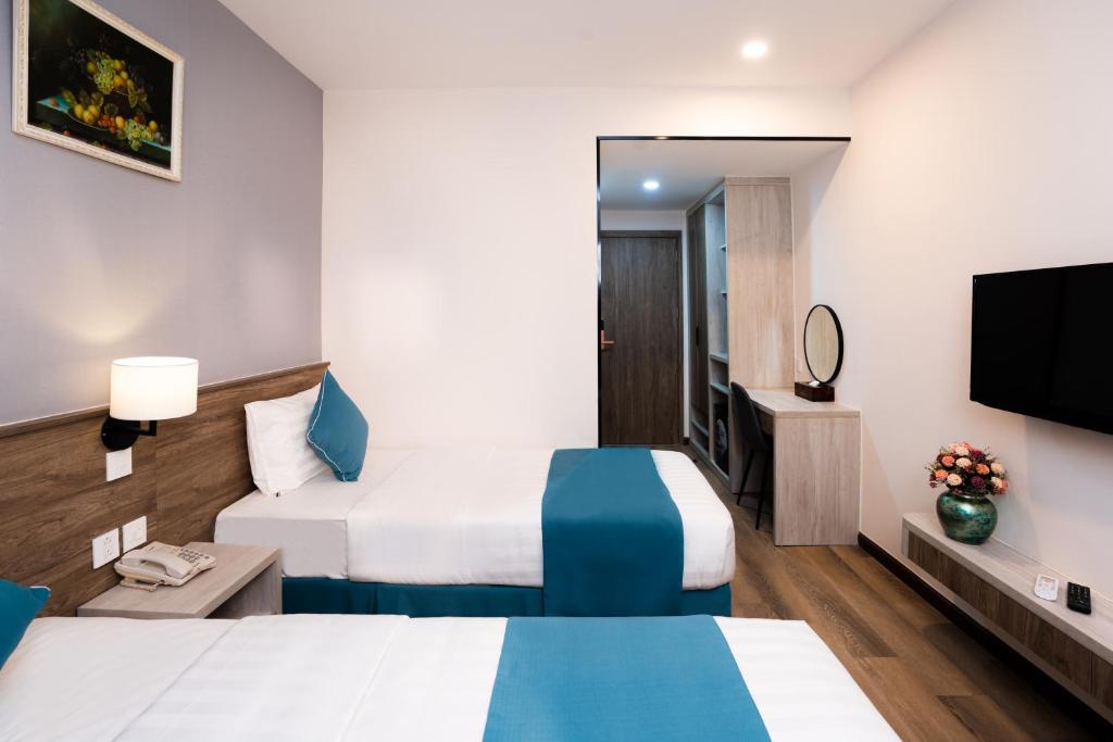 Postel nebo postele na pokoji v ubytování Capital Garden Hotel